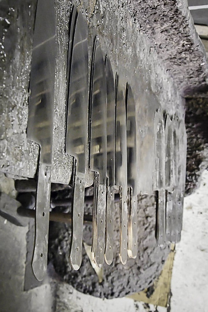 Rows of unfinished knife blades lying on a workshop bench in Solingen